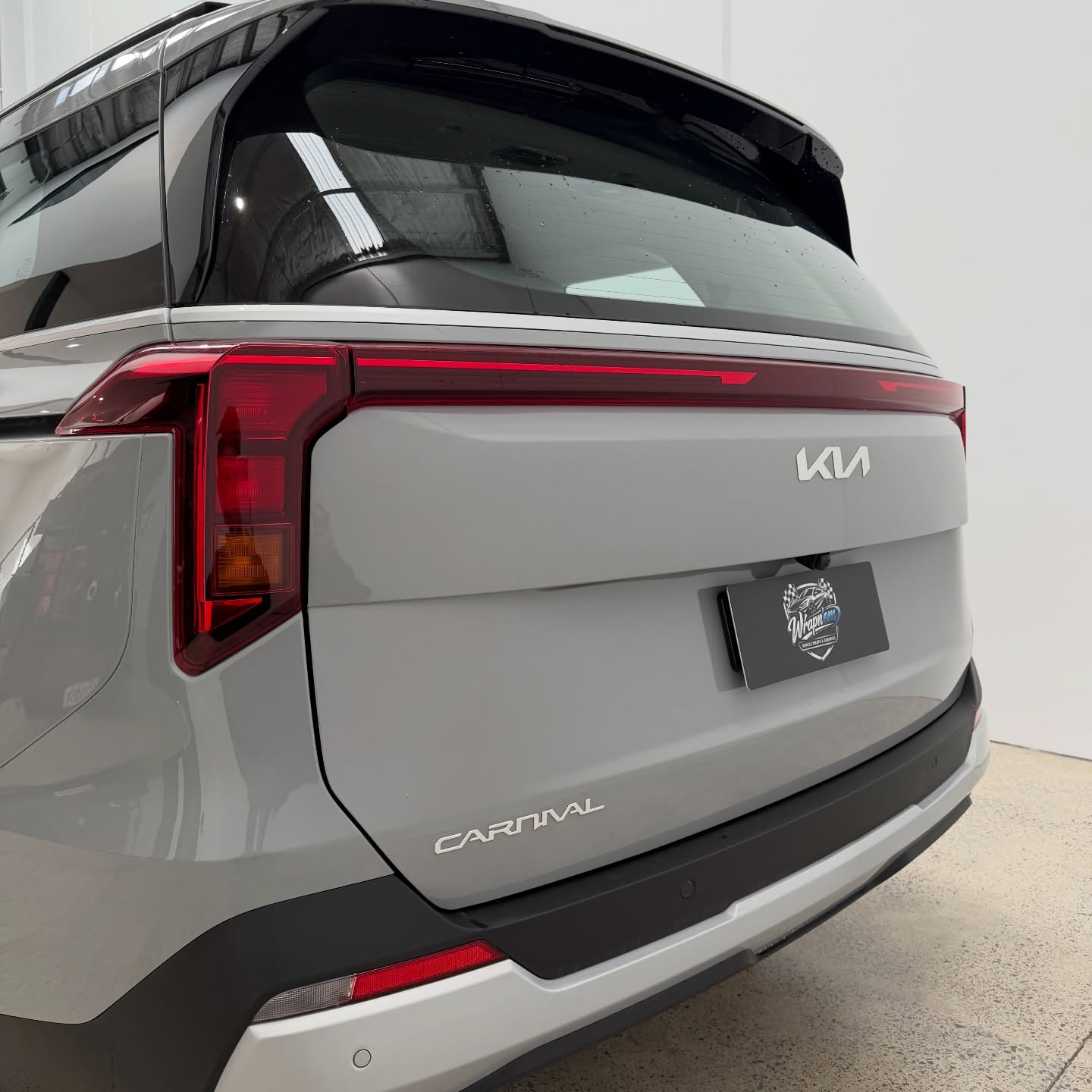 2026 Kia Carnival wrapped in Gloss Obsidian Black, shot 10